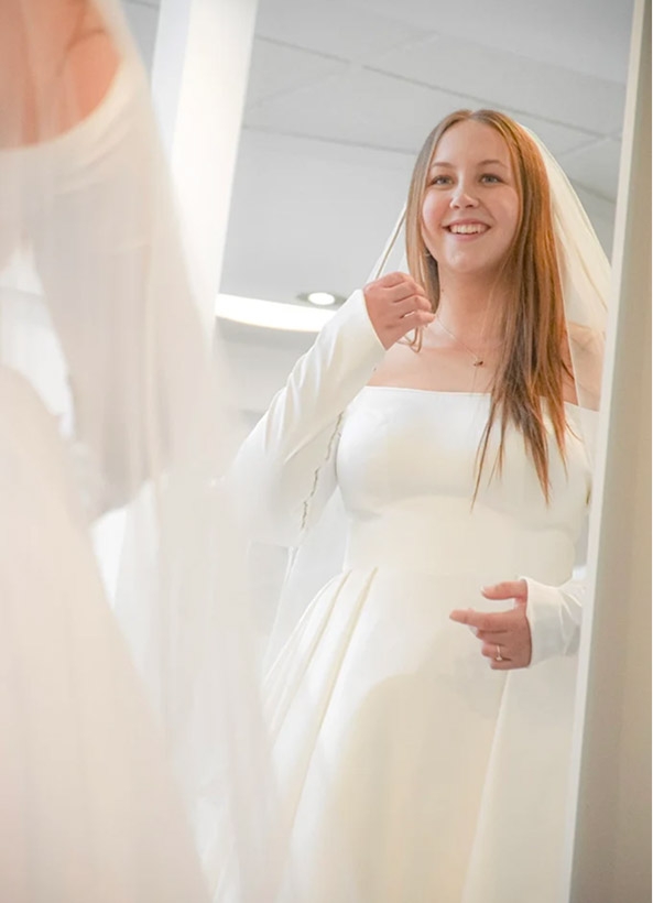 Photo of the model wearing a white bridal gown